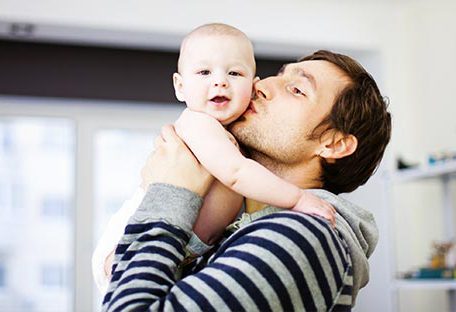dad kissing his baby