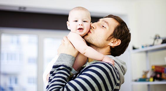 dad kissing his baby